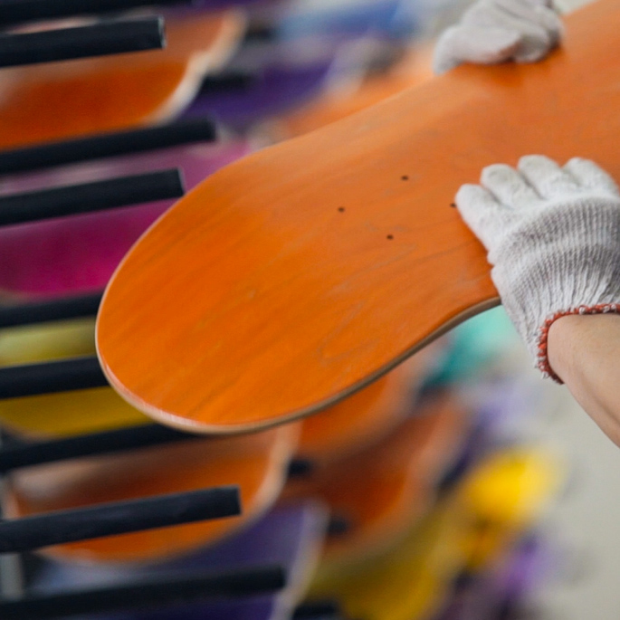 Workers inspecting skateboard decks