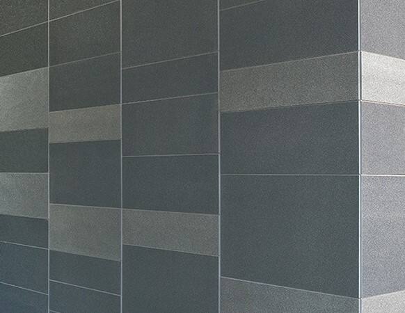 Detail close-up of honed sandstone veining on an exterior cladding panel